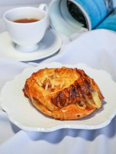 a pastry on a plate with a cup of coffee at Sheraton Shanghai Jiading Hotel in Jiading