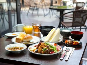 a table with plates of food and drinks on it at Hotel Hillarys in Osaka