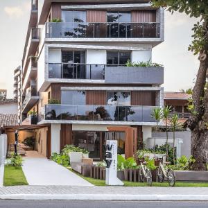 an apartment building with bikes parked in front of it at Way Bossa in Tambaú