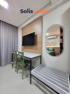 a dining room with a table and chairs and a mirror at Way Bossa in Tambaú