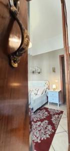 a room with a bed and a door with a mirror at Casa Villani in Agerola