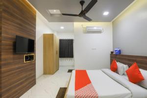 1 dormitorio con 1 cama y TV en la pared en OYO KINGS HOTEL en Katunayaka