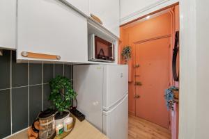 Kuchyň nebo kuchyňský kout v ubytování Appartement Cosy à 2 pas de Paris + 10 fotografií