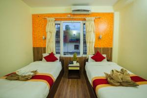 Vuode tai vuoteita majoituspaikassa Hotel Nomad Inn