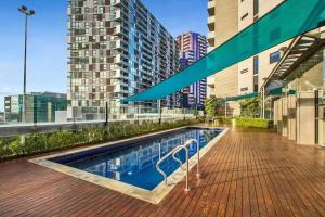 a swimming pool on the roof of a building at VAQUAY Glamptons In Docklands in Melbourne