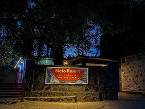 a sign for a bird nest cafe at night at Biafo House in Skardu