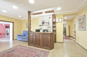 a living room with a blue couch and a table at Hotel Valentini Inn in Foligno