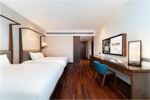 Voodi või voodid majutusasutuse SSAW Boutique Hotel Foshan Qiandeng Lake toas
