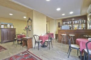 a restaurant with tables and chairs and a bar at Hotel Valentini Inn in Foligno