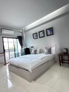 1 dormitorio con 1 cama grande en una habitación en อาร์.เจ.แมนชั่น, en Chonburi