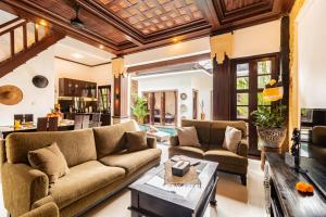a living room with a couch and a table at PROMO Stylish Spacious 3BD Villa in Kerobokan