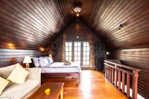 a bedroom with a bed and a couch in a room at PROMO Stylish Spacious 3BD Villa in Kerobokan +46 photos