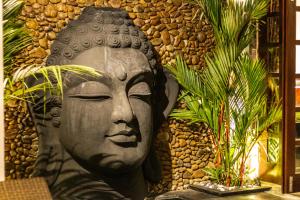 a statue of a head in front of a wall at PROMO Stylish Spacious 3BD Villa in Kerobokan