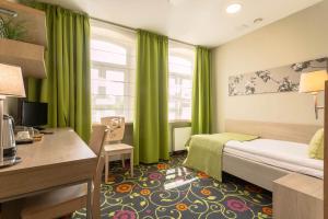 Postel nebo postele na pokoji v ubytování City Hotels Rūdninkai