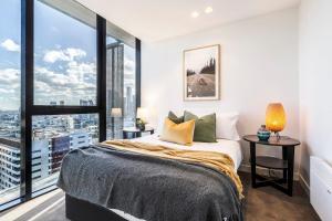 メルボルンにあるVAQUAY Imperial In Southbankのベッドと大きな窓のある寝室 +37枚の写真
