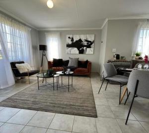 a living room with a couch and a table at Lux Homes Property's in Johannesburg