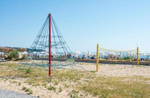 a pole with a net in the middle of a beach at Bulgapart Obzor in Obzor
