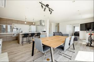 a kitchen and living room with a wooden table and chairs at 104号室 海の見えるシェアハウスRoopt Hayama Collective Houseの一室 in Hayama