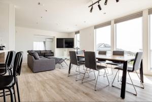 a dining room and living room with a table and chairs at 104号室 海の見えるシェアハウスRoopt Hayama Collective Houseの一室 in Hayama
