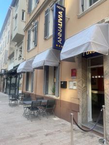 un restaurante con mesas y sillas fuera de un edificio en Hôtel Anna Livia, en Cannes