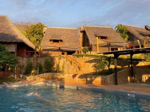a resort with a swimming pool in front of some buildings at lodges cap dore in Andilana