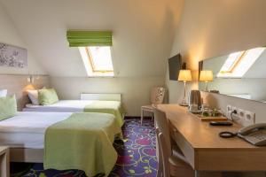 Postel nebo postele na pokoji v ubytování City Hotels Rūdninkai