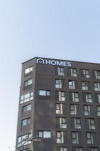 a building with a sign on the side of it at Homes Stay G-Valley Gasan in Seoul