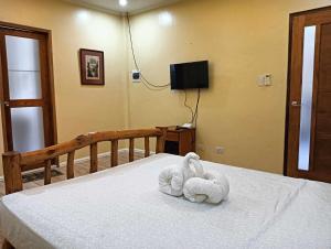 two towels are sitting on a bed in a bedroom at Marietta's Hotel in Bajuyan +3 photos