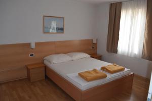 a bedroom with a bed with two towels on it at Apartments Grgic in Novigrad Istria