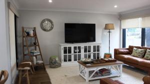 a living room with a couch and a flat screen tv at Pet Friendly With Privacy, Excellence & Wifi in Hawks Nest