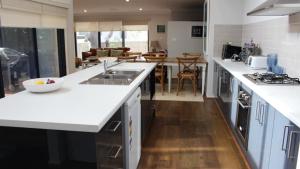 a kitchen with white countertops and a living room at Pet Friendly With Privacy, Excellence & Wifi in Hawks Nest