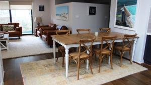 a living room with a wooden table and chairs at Pet Friendly With Privacy, Excellence & Wifi in Hawks Nest