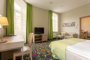 Postel nebo postele na pokoji v ubytování City Hotels Rūdninkai