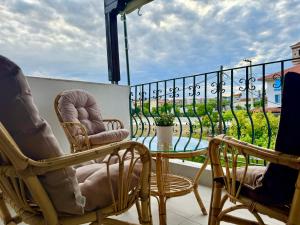a patio with chairs and a glass table on a balcony at Kallithea Central Apartment in Kallithea Halkidikis