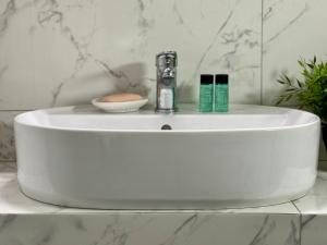 a white bathroom sink with a faucet on it at Kallithea Central Apartment in Kallithea Halkidikis +36 photos