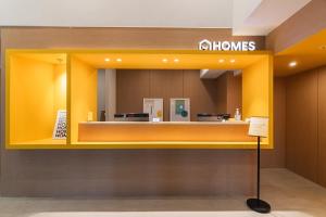 a store with a yellow wall with a mirror at Homes Stay G-Valley Gasan in Seoul