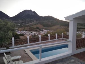 a villa with a swimming pool and mountains in the background at Las Hazuelas Villa 15 in Algámitas