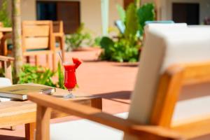 a red drink sitting on top of a table at Samawa Living in Paje