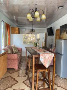 a kitchen and living room with a table and a couch at Cool Breeze Suites 