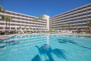 a large swimming pool in front of a large building at INNSiDE by Meliá Alcudia in Port d'Alcudia