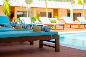 a pool with chaise lounge chairs and a swimming pool at Samawa Living in Paje