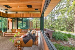 a person laying on a swing in a house at Tally Farm in Upper Tallebudgera