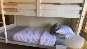 a bunk bed with pillows on it in a room at Hawks Nest's Holiday Gem in Hawks Nest