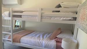 two bunk beds in a room with a bed at Hawks Nest's Holiday Gem in Hawks Nest