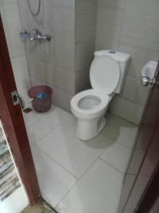 ein Badezimmer mit einem weißen WC in einer Kabine in der Unterkunft Alabang Staycation in Manila