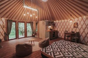 a room with a bed and a desk in a yurt at Klidný Kout glamping in Vysoké Mýto