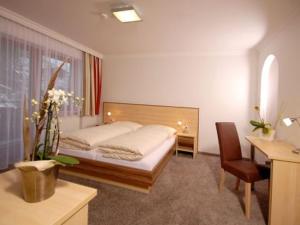 En eller flere senger på et rom på Hotel Sommerer - inklusive Joker Card im Sommer