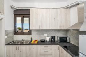 a kitchen with a sink and a microwave at Patima Hills in Chania