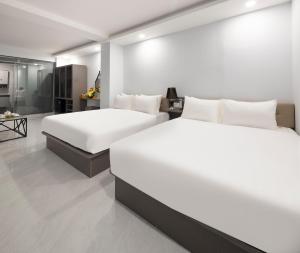 Postel nebo postele na pokoji v ubytování Boss Palace Hotel