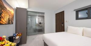 Postel nebo postele na pokoji v ubytování Boss Palace Hotel
